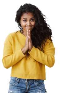 pretty dark skinned young female wearing jeans and yellow sweater with hands pressed together