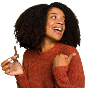 young woman smiling looking back holding a key